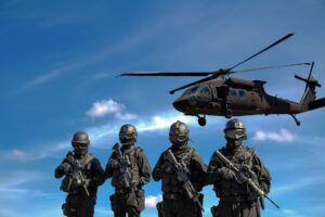 four soldiers carrying rifles near helicopter under blue sky